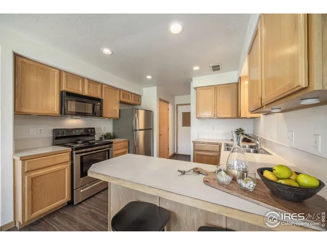 a kitchen that has a sink a window and stainless steel appliances