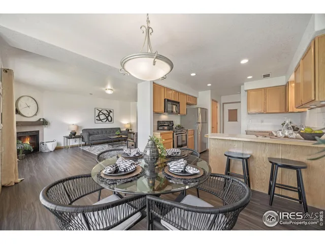 a dining room with furniture a chandelier and wooden floor