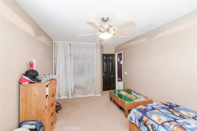 a bedroom with bed and a chandelier
