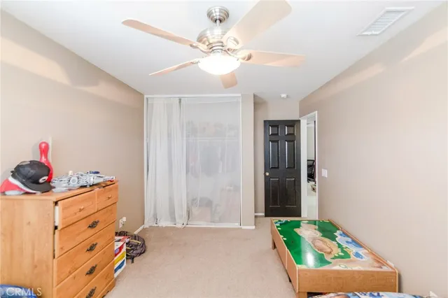 a bedroom with a bed and a dresser in it