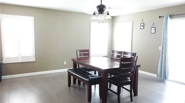 a view of a dining room with furniture and window