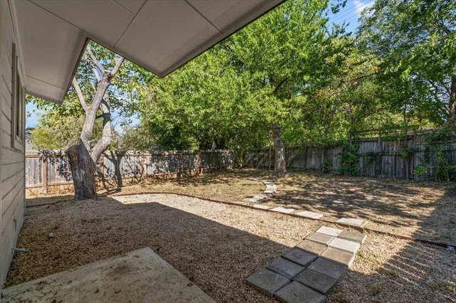 a view of a yard with a tree