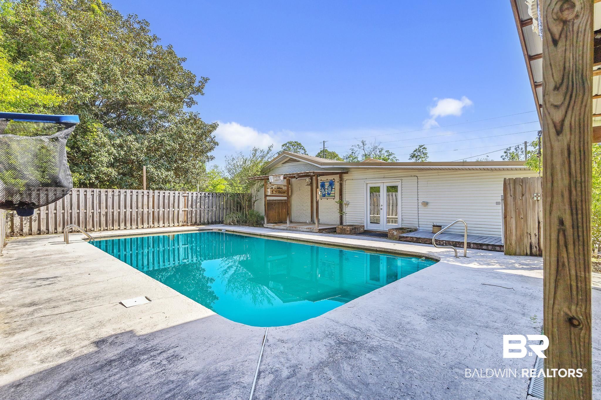 11964 Stroh Road Daphne, AL 36527 - Photo 56 of 58 View of swimming pool with a fenced in pool, a patio area, french doors, and a fenced backyard