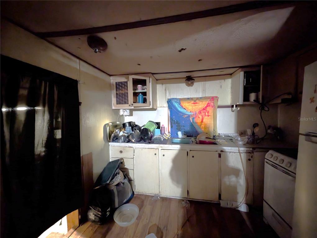 2516 Hebb Road Auburndale, FL 33823 - Photo 11 of 55 a kitchen with stainless steel appliances a refrigerator and wooden floor