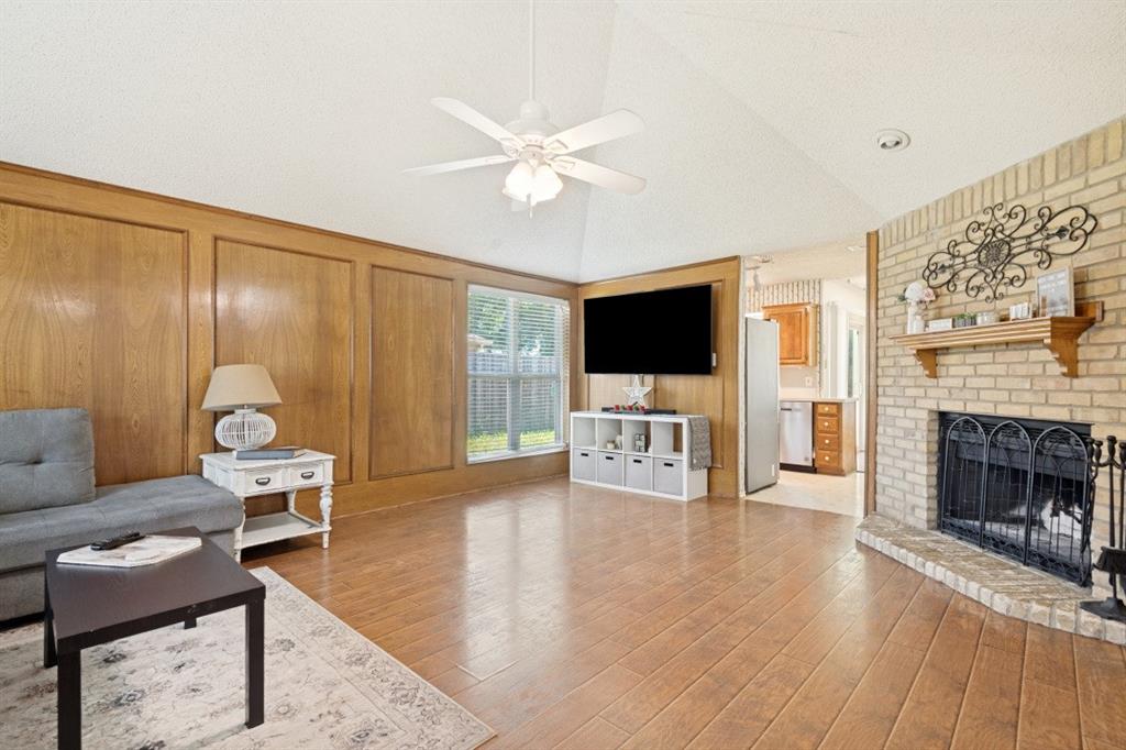 7410 Jessica Way Rowlett, TX 75088 - Photo 7 of 25 a living room with furniture a fireplace and a flat screen tv