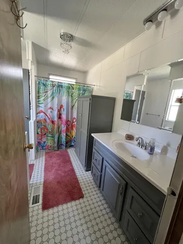 a bathroom with a sink a vanity and a mirror