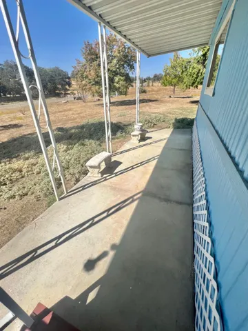a view of a balcony with yard