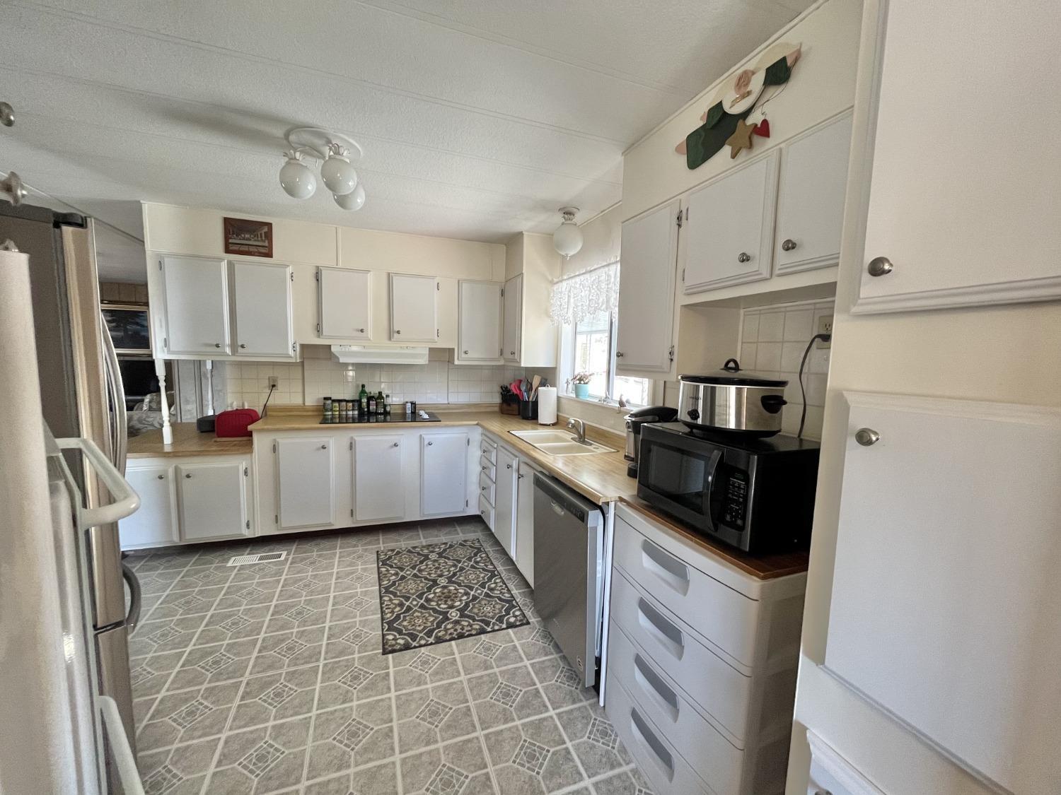 33188 George Smith Road Squaw Valley, CA 93675 - Photo 2 of 43 a kitchen with stainless steel appliances a refrigerator sink and cabinets