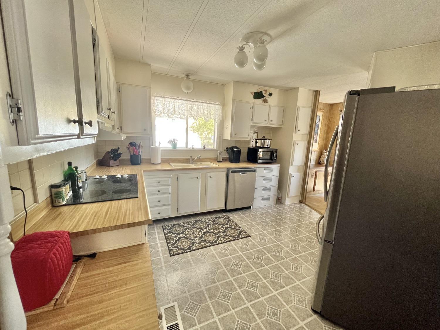 33188 George Smith Road Squaw Valley, CA 93675 - Photo 3 of 43 a large kitchen with a stove a refrigerator and a sink