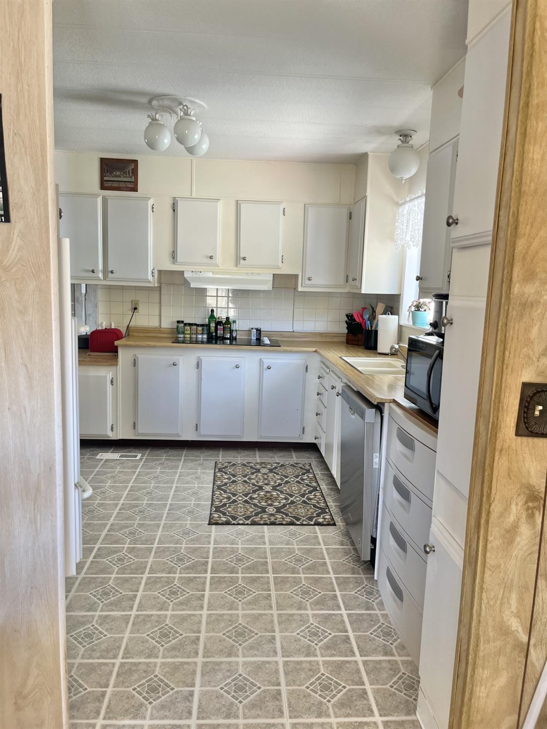 33188 George Smith Road Squaw Valley, CA 93675 - Photo 4 of 43 a kitchen with a sink a stove and cabinets