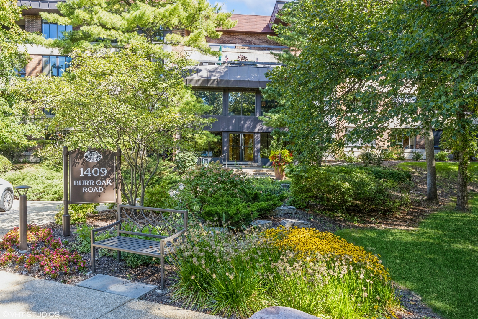 1409 Burr Oak Road, Unit 315A Hinsdale, IL 60521 - Photo 1 of 22 a sign that is sitting in the middle of a garden