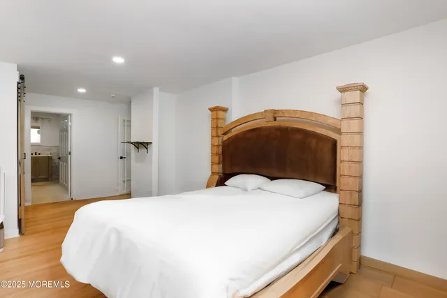 a bedroom with a bed and a mirror