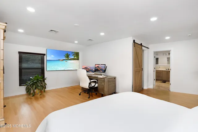 a bedroom with a bed and a potted plant