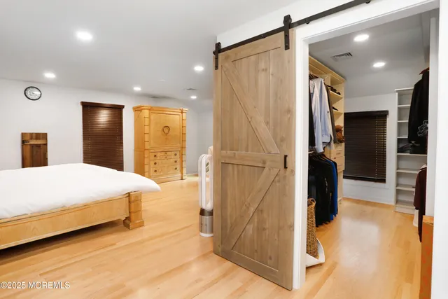 a bed room with a bed and a large mirror