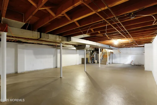 a view of water heater room with stairs