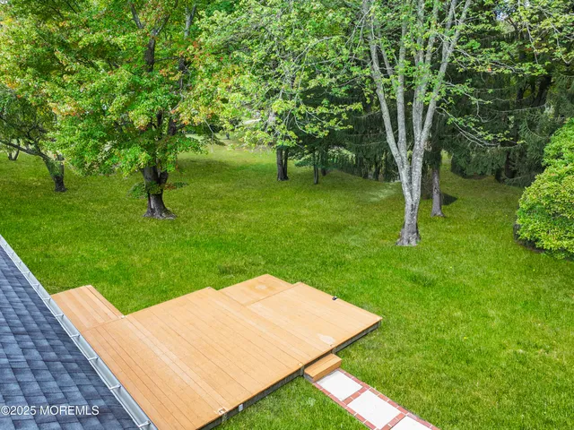 a view of a backyard with large trees