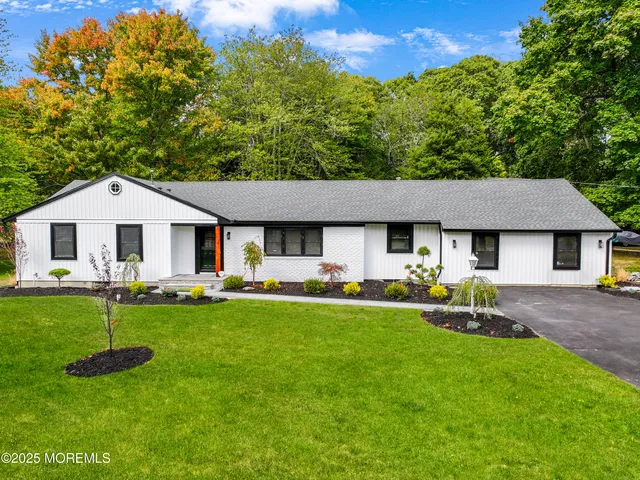 a aerial view of a house with a yard patio and fire pit
