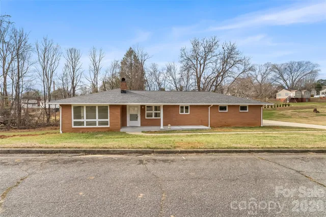 a large kitchen with stainless steel appliances granite countertop a sink and dishwasher a stove with wooden floor