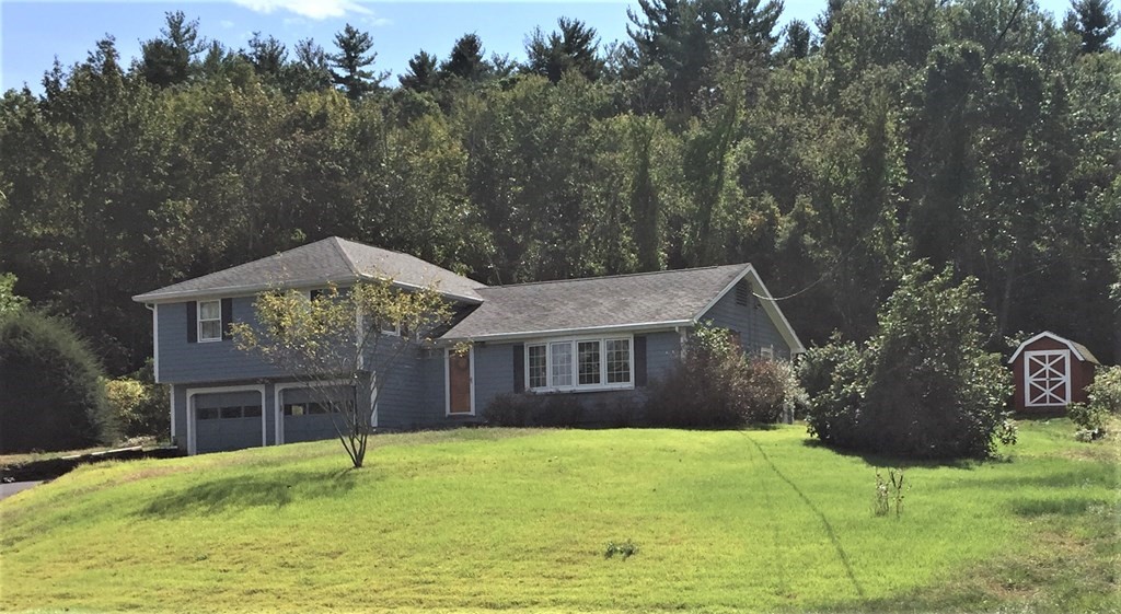 1175 Bay Road Amherst, MA 01002 - Photo 1 of 34 a front view of a house with a garden