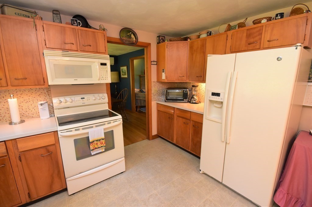 1175 Bay Road Amherst, MA 01002 - Photo 11 of 34 a kitchen with a refrigerator stove and white cabinets