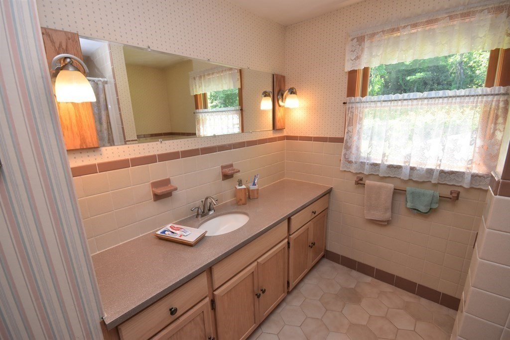 1175 Bay Road Amherst, MA 01002 - Photo 21 of 34 a bathroom with a granite countertop sink mirror and window