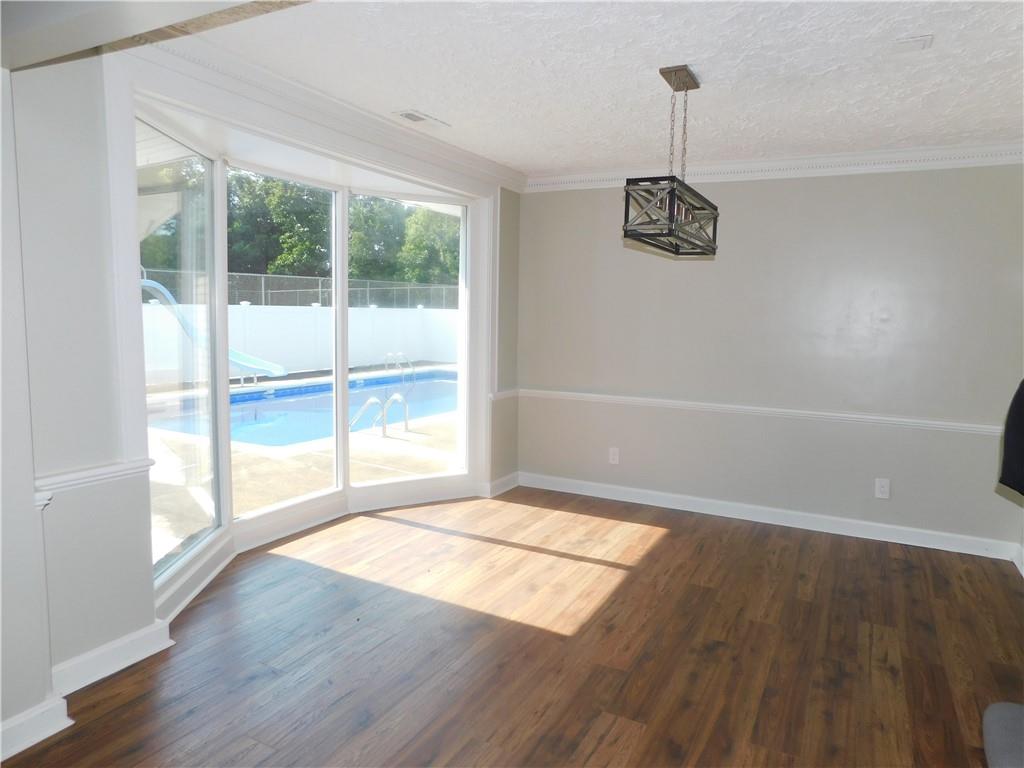 431 Old Rt 21 Road McClellandtown, PA 15458 - Photo 8 of 25 a view of an empty room with wooden floor and a window