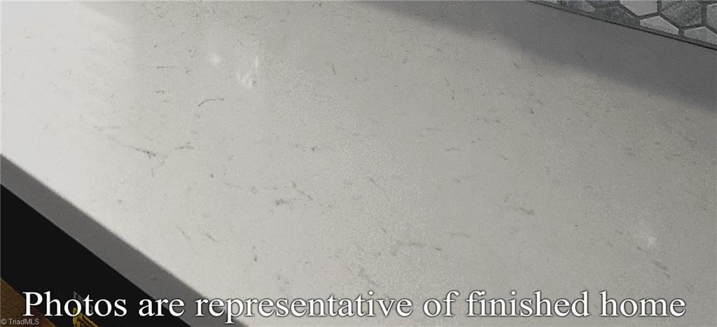 3429 Littlefield Way Greensboro, NC 27405 - Photo 19 of 40 Those beautiful quartz counters and tile backsplash are upgrades - both included!