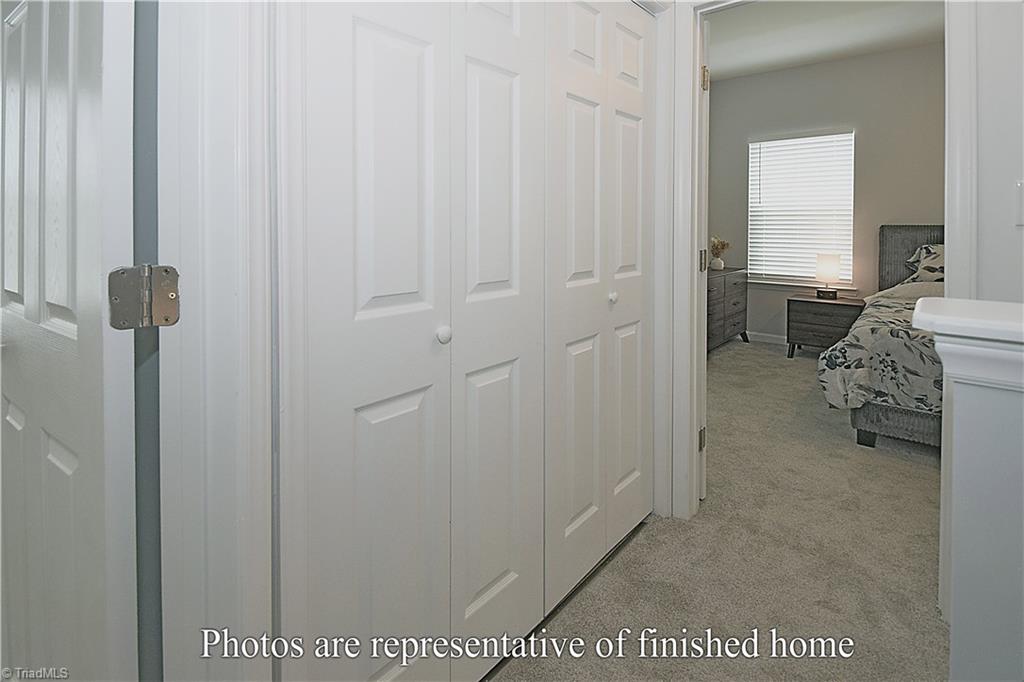 3429 Littlefield Way Greensboro, NC 27405 - Photo 23 of 40 The launder closet is on the left in this photo - it adjacent to both the primary suite bedroom 2 and the shared full bath.