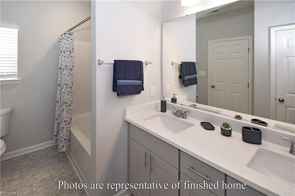 3429 Littlefield Way Greensboro, NC 27405 - Photo 28 of 40 Spacious is a key word here as well, with double vanities, a linen closet and bath/shower area.