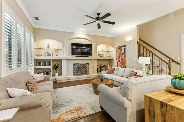 a living room with furniture fireplace and a large window