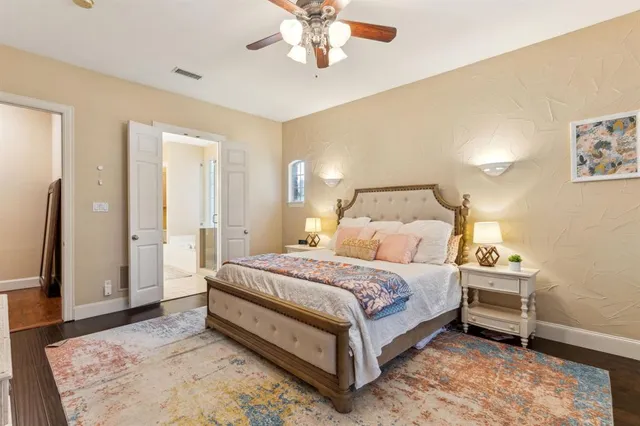 a bedroom with a bed and a dresser with rug