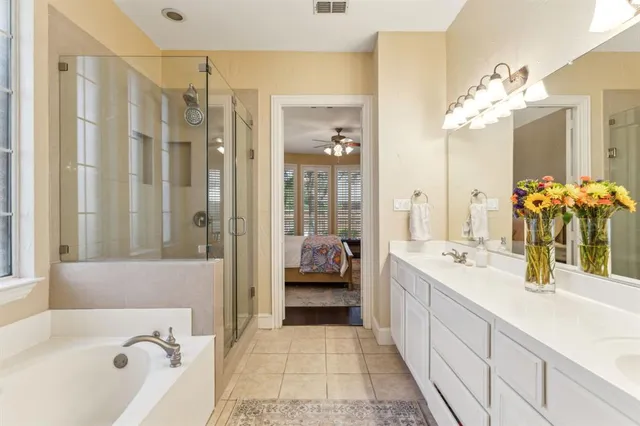 a bathroom with a tub sink and mirror