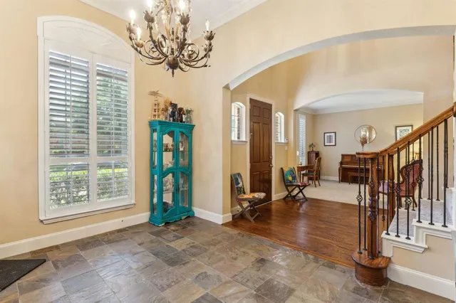 a view of hall way with mirror and windows