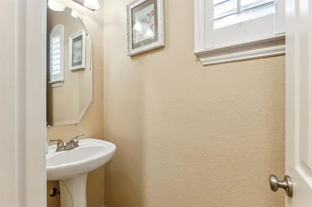 a bathroom with a sink a mirror and vanity