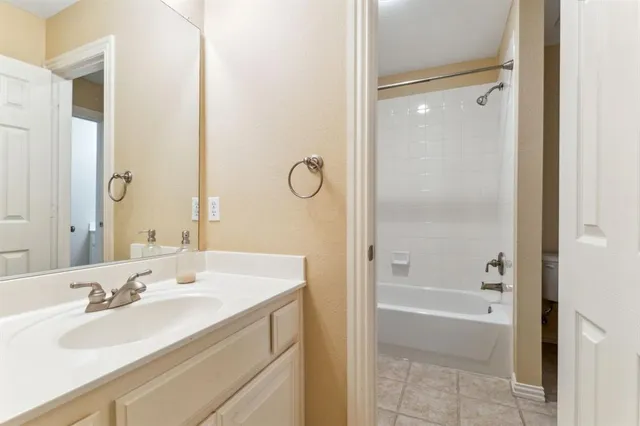 a bathroom with a bath tub sink mirror and a shower