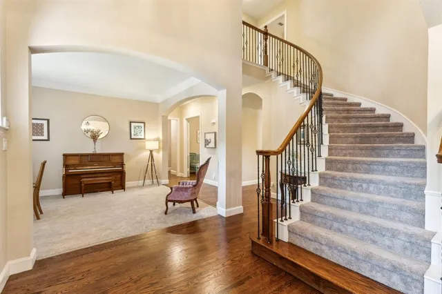a view of entryway livingroom and hall with wooden floor