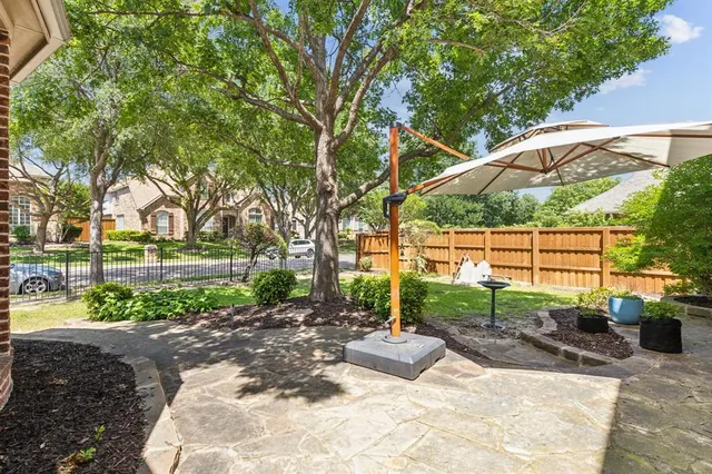 a view of a backyard with a garden and entertaining space