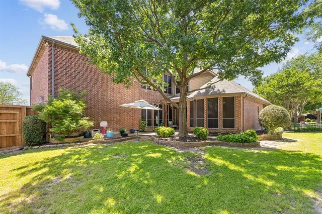 a backyard of a house with yard and outdoor seating