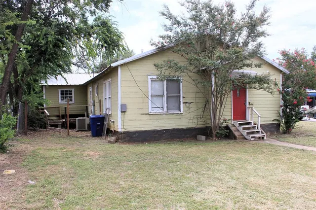 a view of a house with backyard porch and sitting area