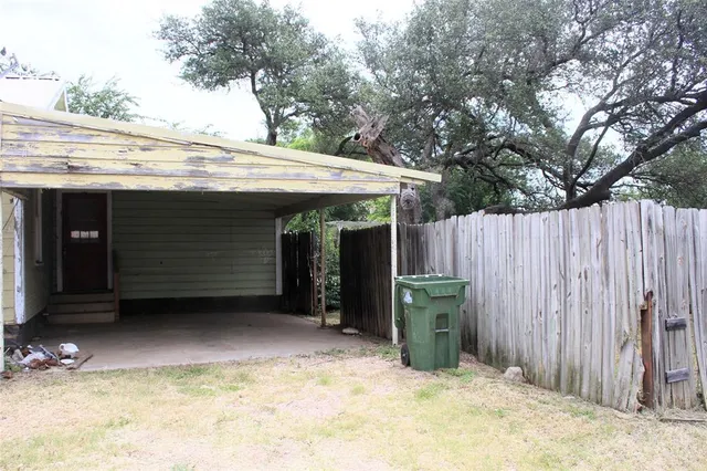 a view of a house with a backyard and a garage
