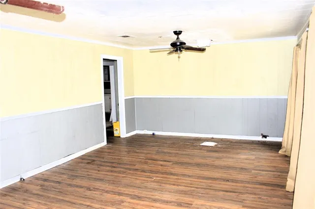 a view of a room with wooden floor