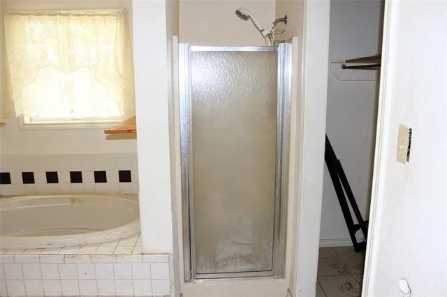a view of a hallway with wooden floor and entryway