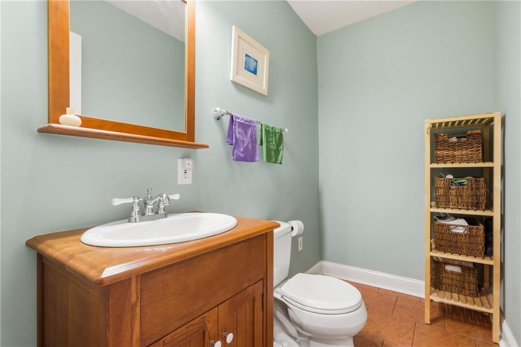 1127 Portland Street Pittsburgh, PA 15206 - Photo 16 of 50 a bathroom with a toilet a sink and a mirror