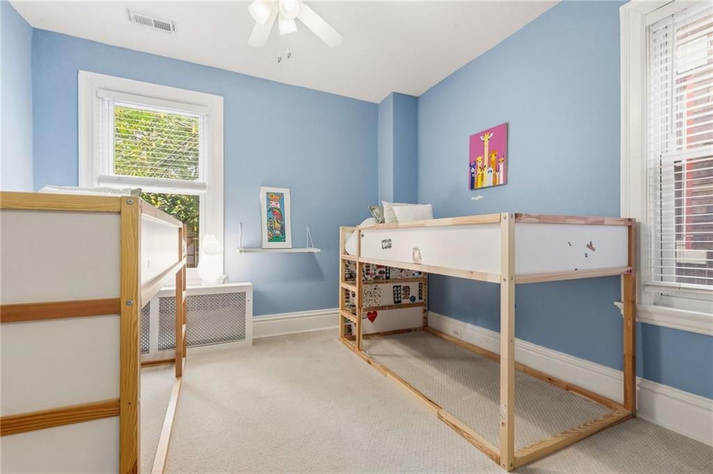 1127 Portland Street Pittsburgh, PA 15206 - Photo 26 of 50 a room with a bed and a table