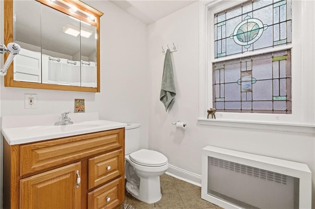 1127 Portland Street Pittsburgh, PA 15206 - Photo 28 of 50 a bathroom with a toilet sink and mirror