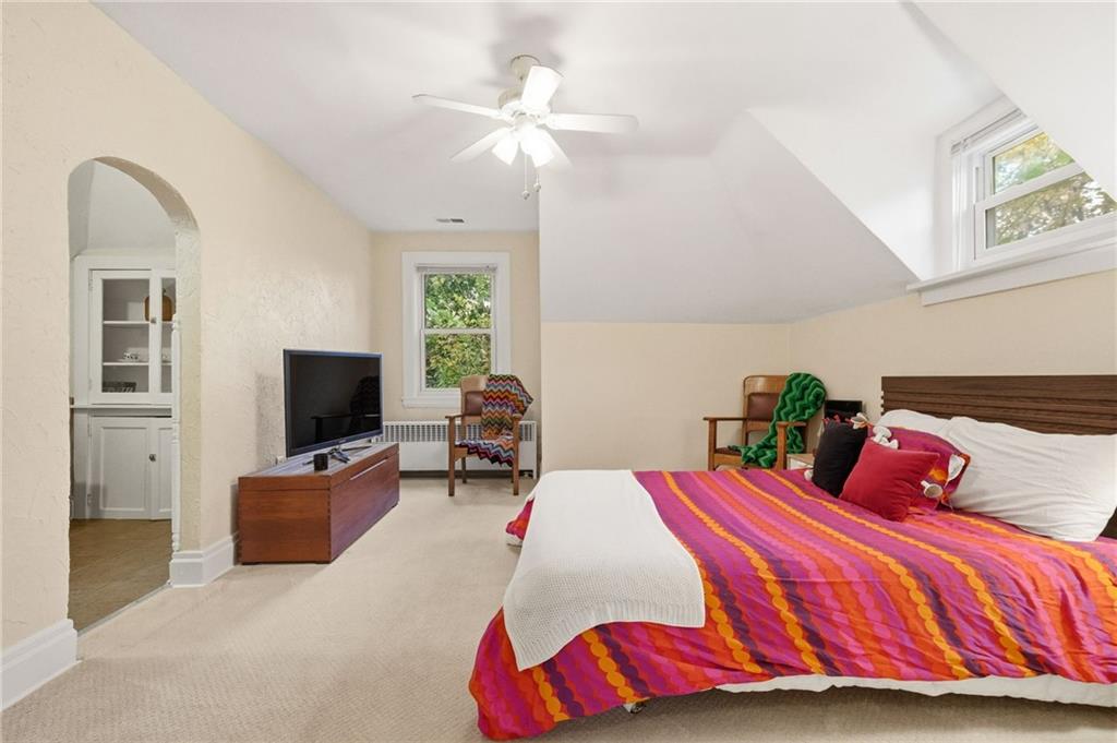 1127 Portland Street Pittsburgh, PA 15206 - Photo 31 of 50 a bedroom with a bed and a flat screen tv