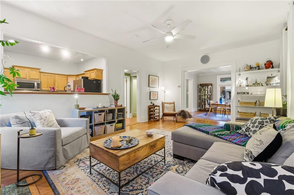 1127 Portland Street Pittsburgh, PA 15206 - Photo 8 of 50 a living room with furniture and a chandelier
