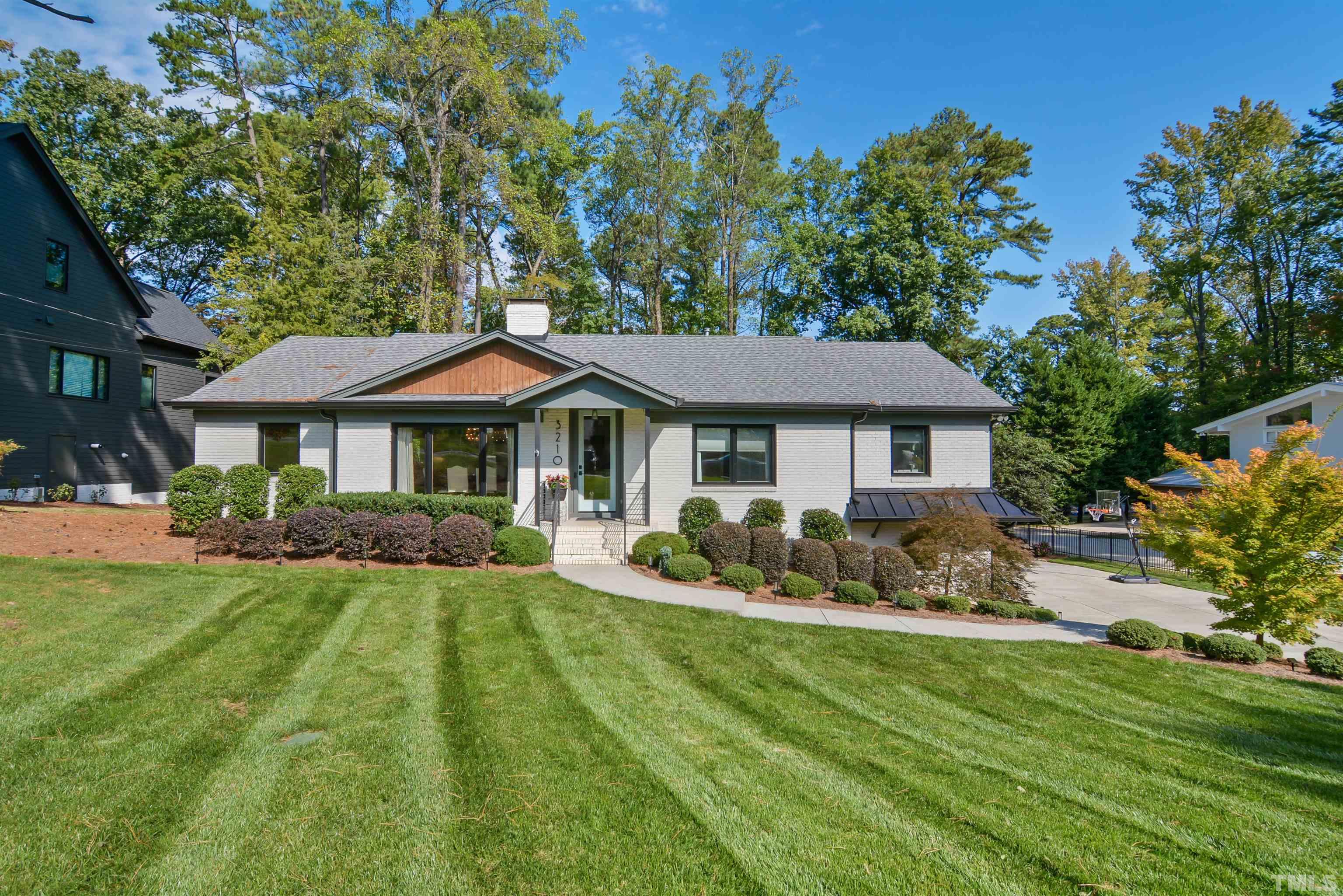 a front view of a house with a garden and porch
