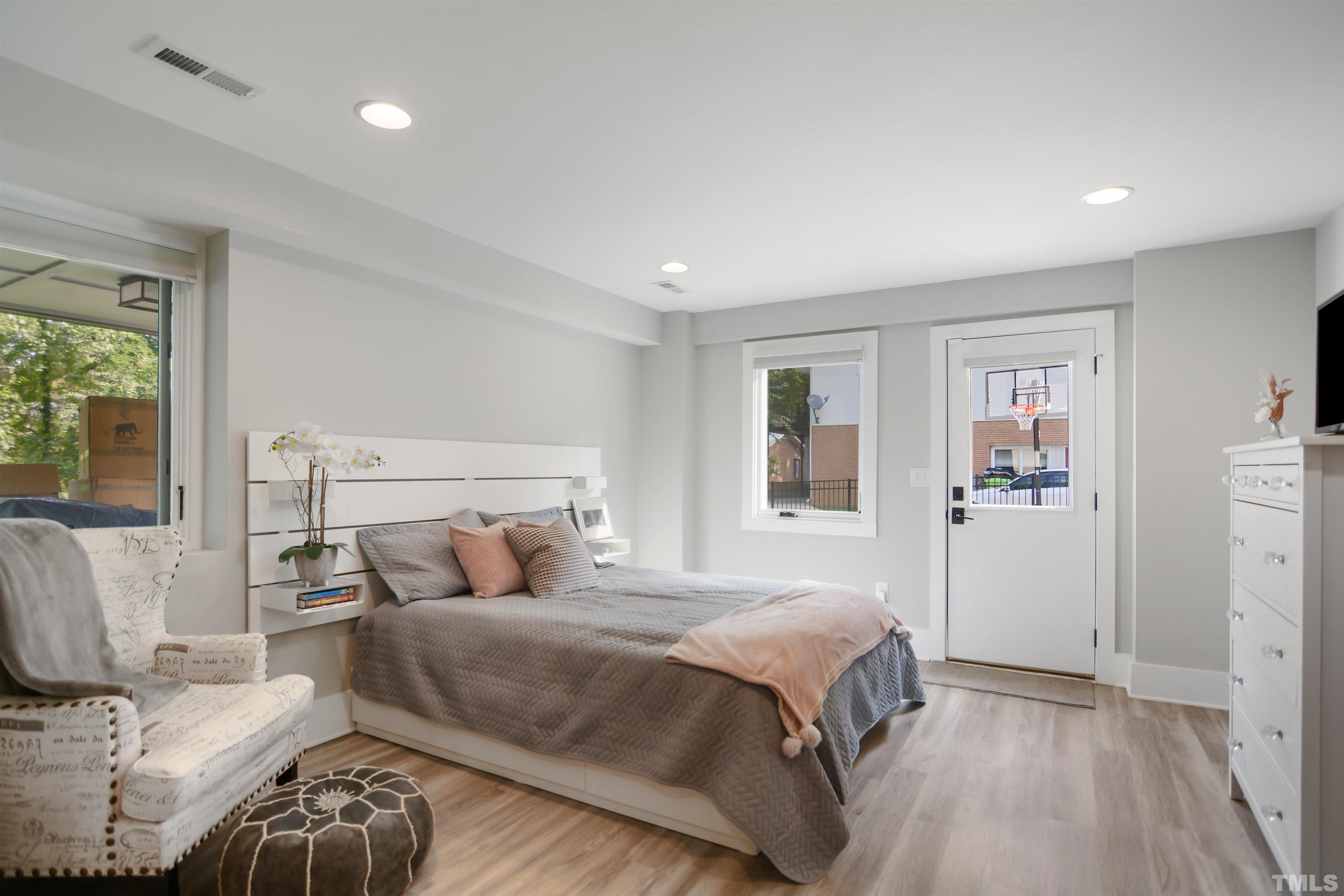 3210 Hampton Road Raleigh, NC 27607 - Photo 25 of 34 a bedroom with a bed and wooden floor