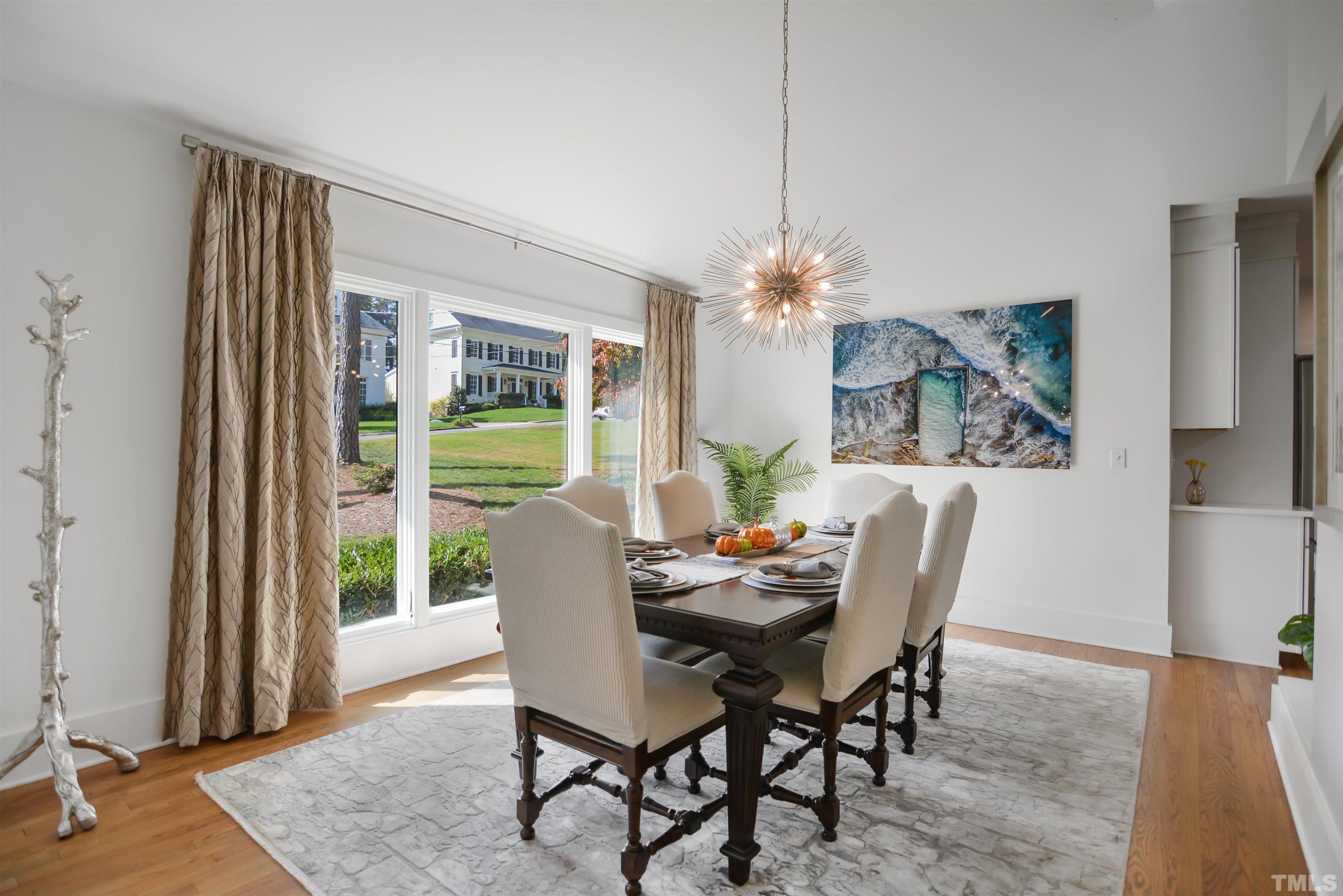 3210 Hampton Road Raleigh, NC 27607 - Photo 3 of 34 a dining room with furniture a rug and a chandelier